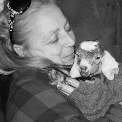 Writer Dovely holding her baby goat