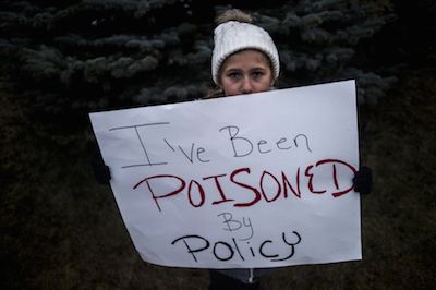 A little girl protesting the water crisis in Flint, America.