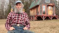 Burt's Bees founder next to his Cabin in the woods