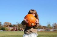 Girl holding pumpkin